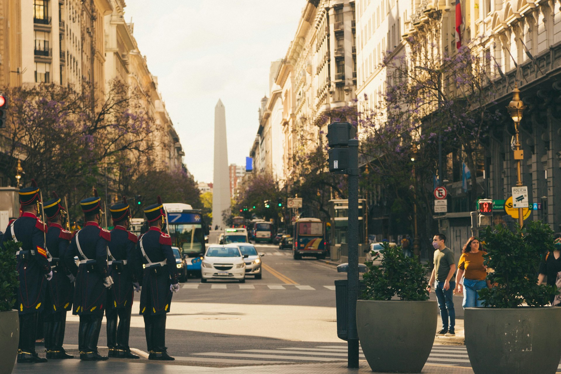 a group of men in uniform standing in the middle of a street